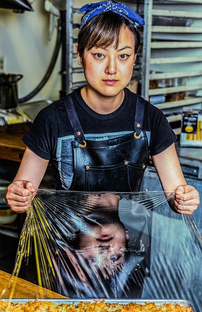 female chef using plastic wrap